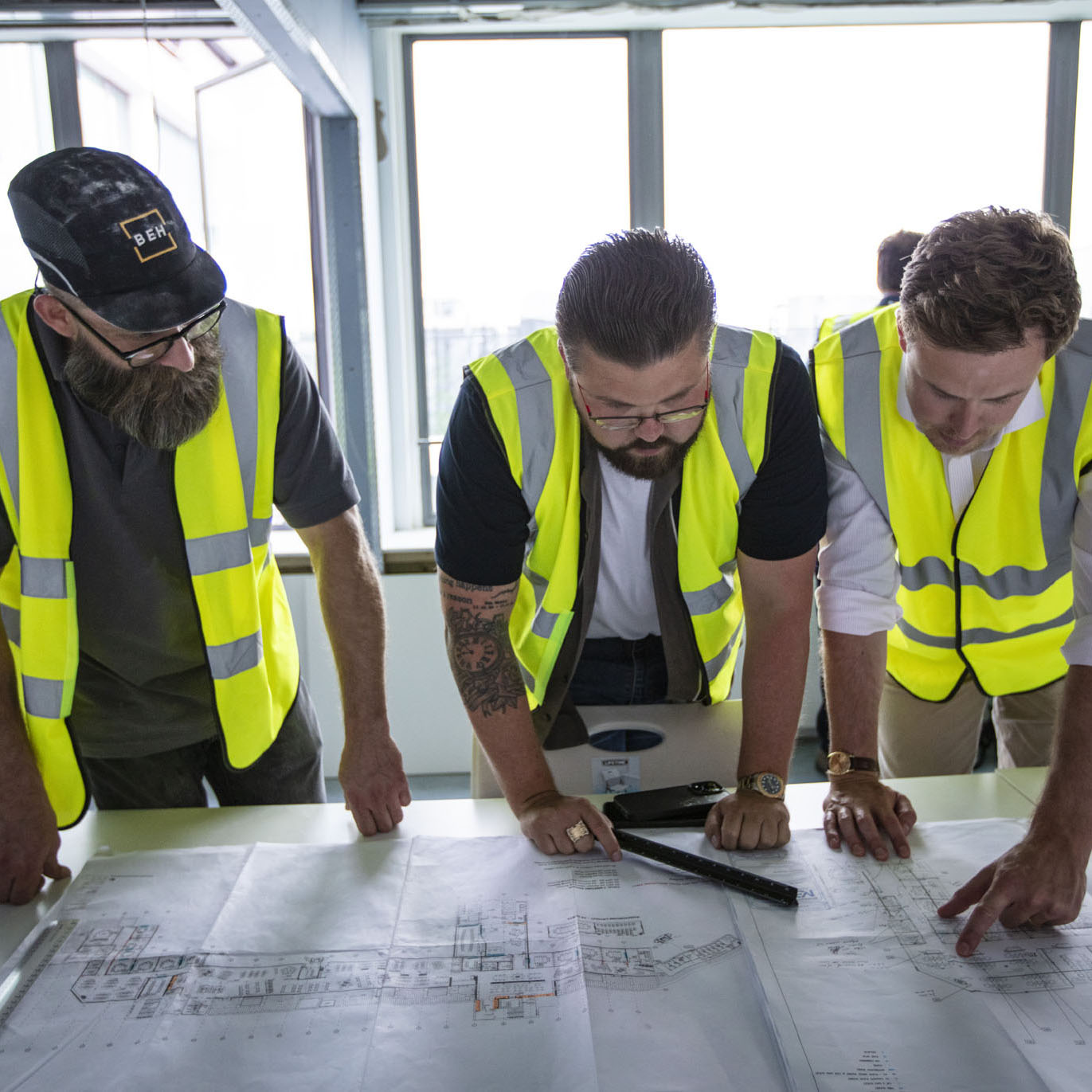 BEH team looking at plans for an office fitout project