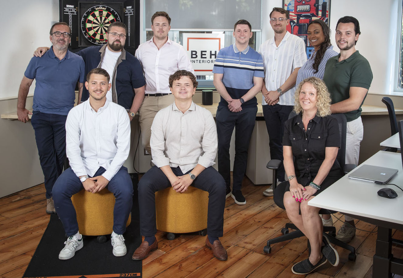 BEH Interiors team gathered inside their office, showcasing the company’s professional fit-out and project management staff.