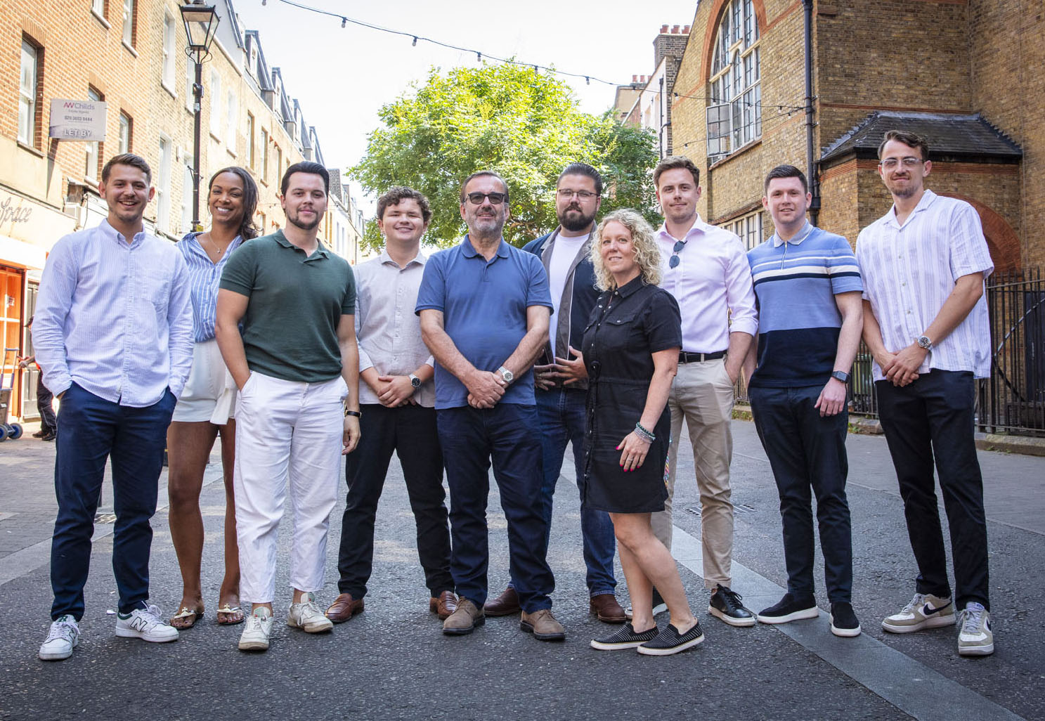 BEH Interiors team standing together outdoors in London, representing their commercial office fit-out company.